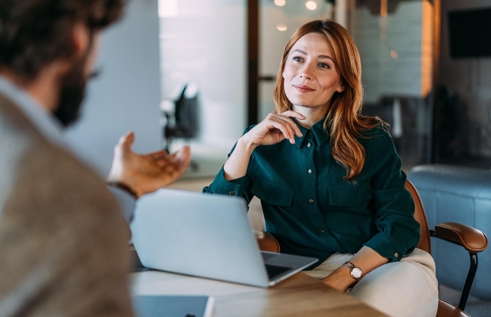 Shot of two colleagues having a discussion in the office. Creative business persons discussing new project and sharing ideas in the workplace.