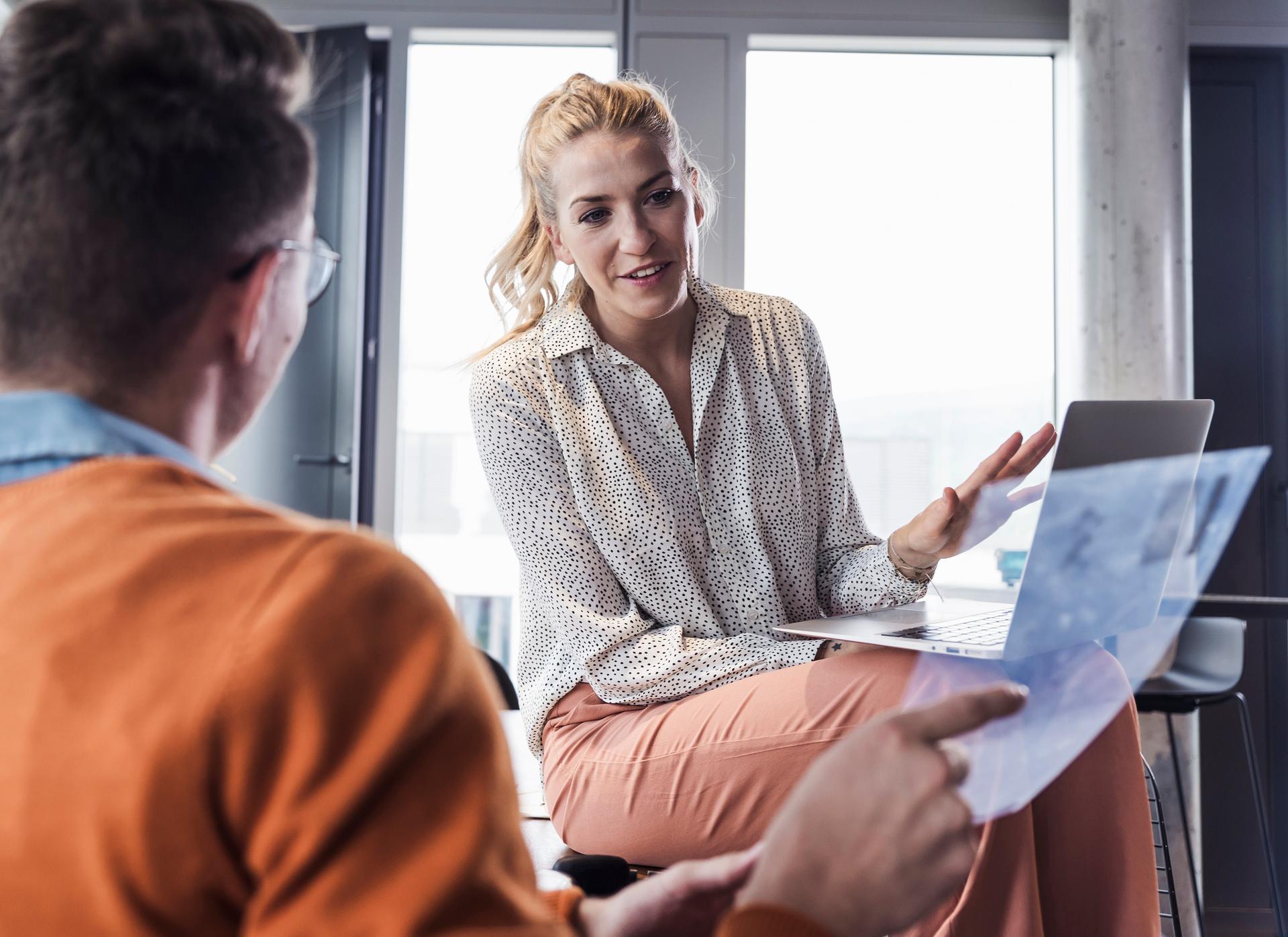 Business professionals discussing work in a modern office setting